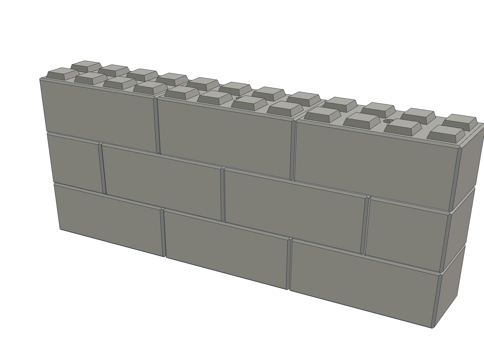 A wall of interlocking concrete blocks cast from the mould
